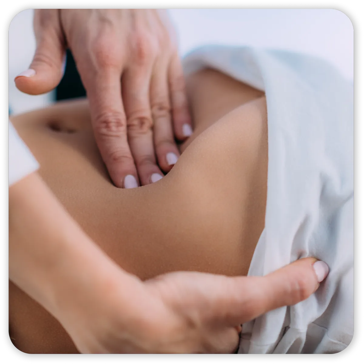 tmpgeq5tdgl Hands performing abdominal massage therapy session.